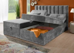 Boxspringbett mit individueller Kopfteilverstellung und Deko-Kissen